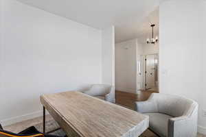 Office featuring a chandelier and light wood-style flooring