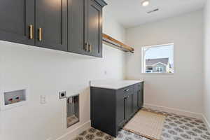 Laundry area featuring cabinet space, washer hookup, hookup for an electric dryer, and recessed lighting