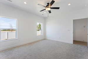 Spare room with carpet floors, a ceiling fan, and recessed lighting