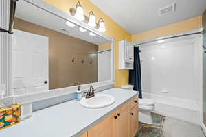 Bathroom with shower / bath combo with shower curtain and vanity