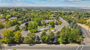 Aerial view of property's location with nearby suburban area and a tree filled landscape