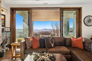 Living room featuring plenty of natural light, a mountain view, and wood finished floors
