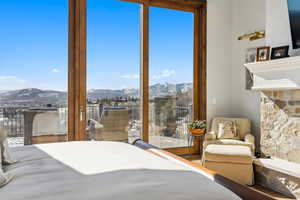 Bedroom with access to exterior and a mountain view