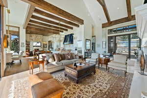 Living area with a fireplace, recessed lighting, wood finished floors, and vaulted ceiling