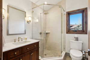 Full bath with a stall shower and vanity