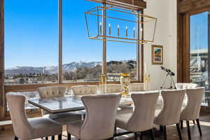 Dining space with a mountain view and wood finished floors