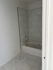 Full bathroom with tub / shower combination and marble finish floors