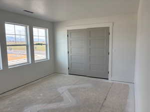 Unfurnished bedroom with a closet and baseboards