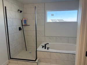 Bathroom featuring a garden tub and a walk in shower