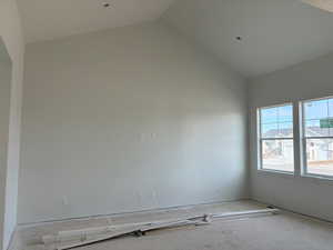 Unfurnished room with a high ceiling