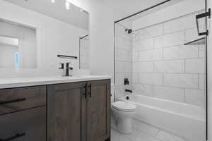 Full bathroom featuring vanity, washtub / shower combination, and light marble finish floors