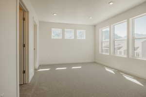 Spare room with light colored carpet and recessed lighting