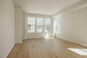 Spare room featuring light wood-type flooring, recessed lighting, and a mountain view
