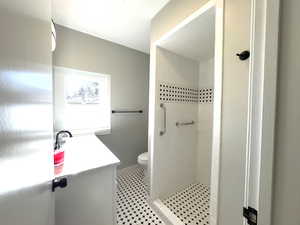 Bathroom featuring a shower and vanity upgraded toilet.