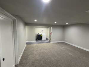 Laundry Room, next to family room. Carpet flooring, recessed lighting, and separate, (included) washer and dryer.