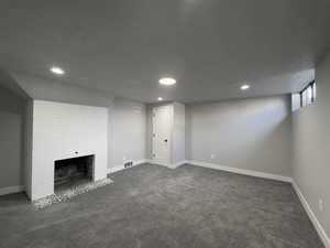 (#5) Bedroom, brick wood burning fireplace,  recessed lighting, carpeting.