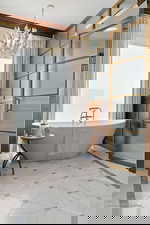 Full bathroom with a freestanding bath and a chandelier