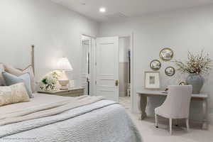 Bedroom featuring light carpet, recessed lighting, and a desk