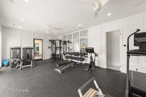 Gym with a decorative wall, ceiling fan, and recessed lighting