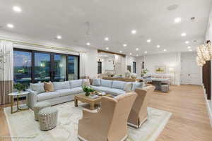 Living room with light wood finished floors and recessed lighting