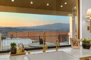 Balcony featuring a mountain view and a sink