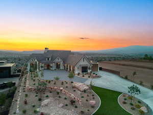 View of front of house with a porch, a chimney, and concrete driveway