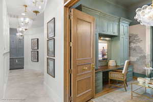 Office with suspended lighting and crown molding