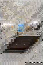 Bathroom with vanity and wallpapered walls