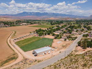 Aerial overview of property's location with a mountainous background and rural landscape