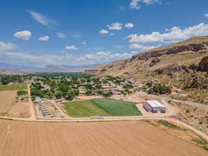 Overview of rural landscape featuring a mountainous background and large plots for crops