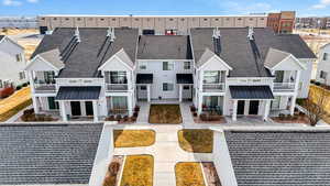 Back of property featuring a balcony, a shingled roof, french doors, and a standing seam roof