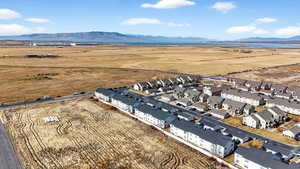 Overview of rural landscape with a mountainous background and nearby suburban area
