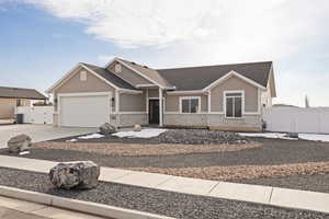 Craftsman-style patio home with vinyl fencing, driveway with RV parking, an attached garage, and a shingled roof