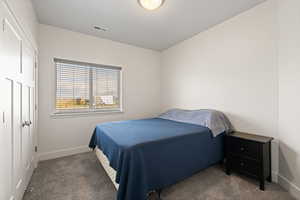 Carpeted bedroom featuring light colored paint