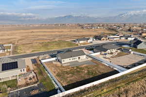 Aerial view of rural suburban area featuring mountain backdrop