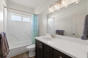 Full bathroom with vanity, shower / bath combo, and LVP floors