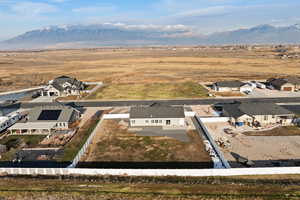 Aerial view of rural suburban area featuring mountain backdrop