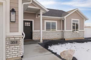 Entrance to property featuring brick and hardie-siding
