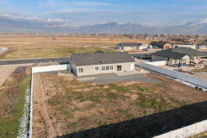 Aerial view of rural suburban area featuring mountain backdrop