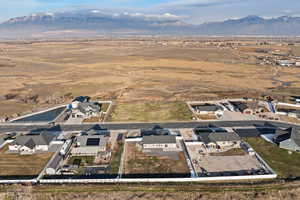 Aerial view of property's location featuring suburban area and rural landscape with mountain backdrop