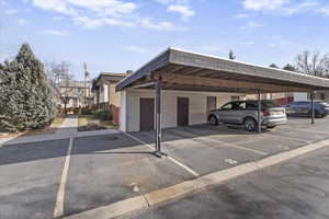 Two dedicated parking spaces plus a storage shed under the carport.