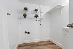 Dedicated laundry room with storage shelves.