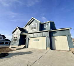 Modern farmhouse with board and batten siding and concrete driveway