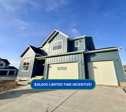 Modern inspired farmhouse with board and batten siding, an attached garage, and driveway