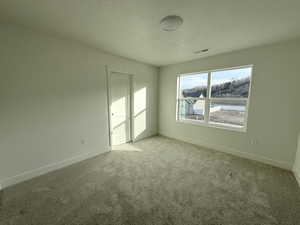 Unfurnished bedroom with a textured ceiling and carpet
