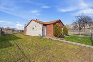 View of home's exterior featuring brick siding and an outbuilding