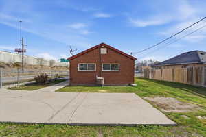 Rear view of house with brick siding and a patio