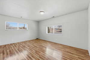 Unfurnished room featuring light wood-type flooring and baseboards