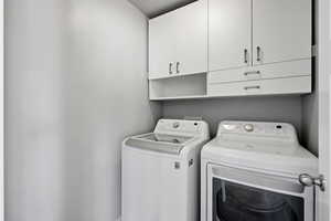 Laundry room featuring cabinet space and washing machine and dryer