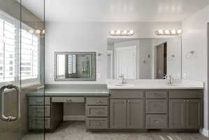 Full bathroom featuring double vanity and a shower stall